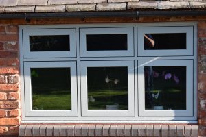 New flush casement window in red brick home.